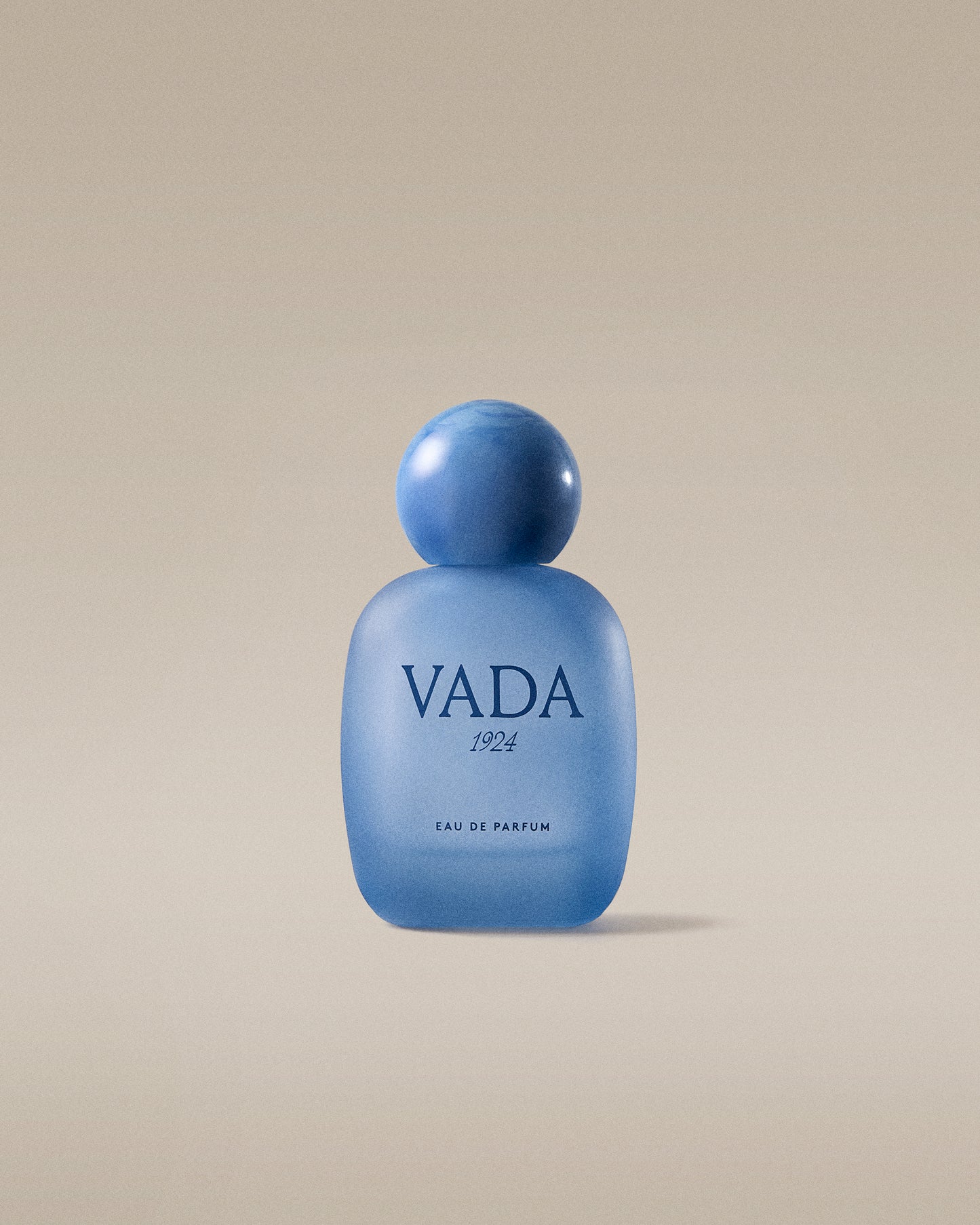 Blue Vada perfume bottle on a beige background