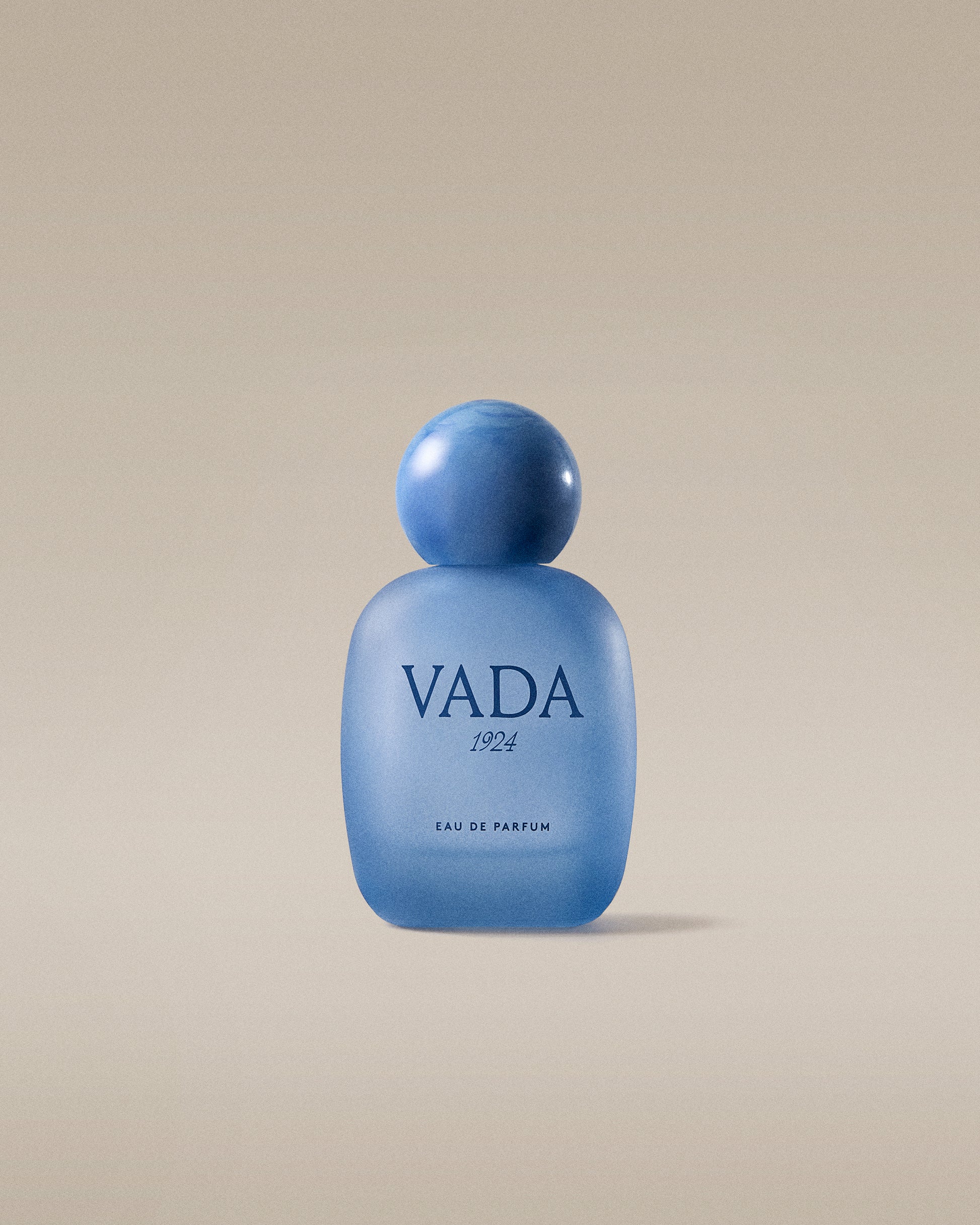 Blue Vada perfume bottle on a beige background