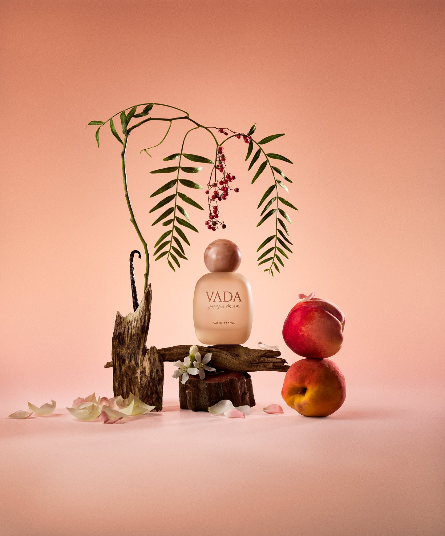 Vada perfume bottle with decorative elements on a pink background
