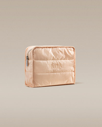 Beige quilted pouch with 'Vada' branding on a beige background